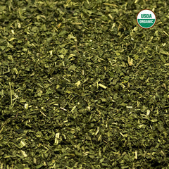 Brewing nettle tea in a cup showing milky tint