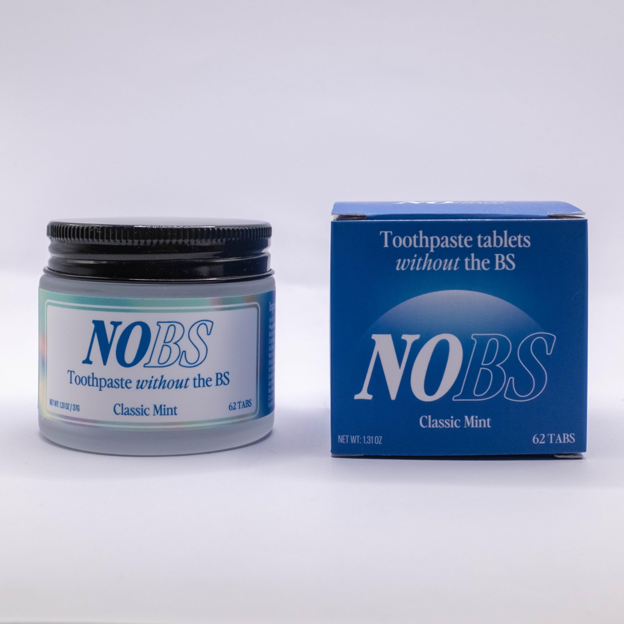 Person brushing teeth with NOBS toothpaste tablets