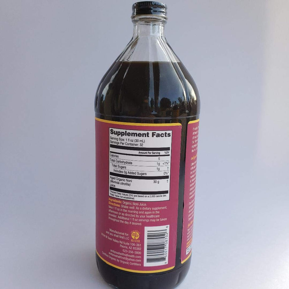 Noni juice in glass bottle with label, side angle