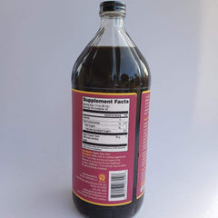 Noni juice in glass bottle with label, side angle