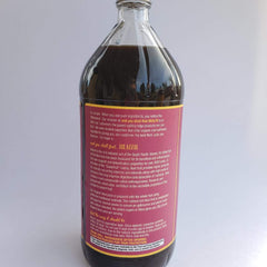 Close-up of Noni fruit and bottle ingredients