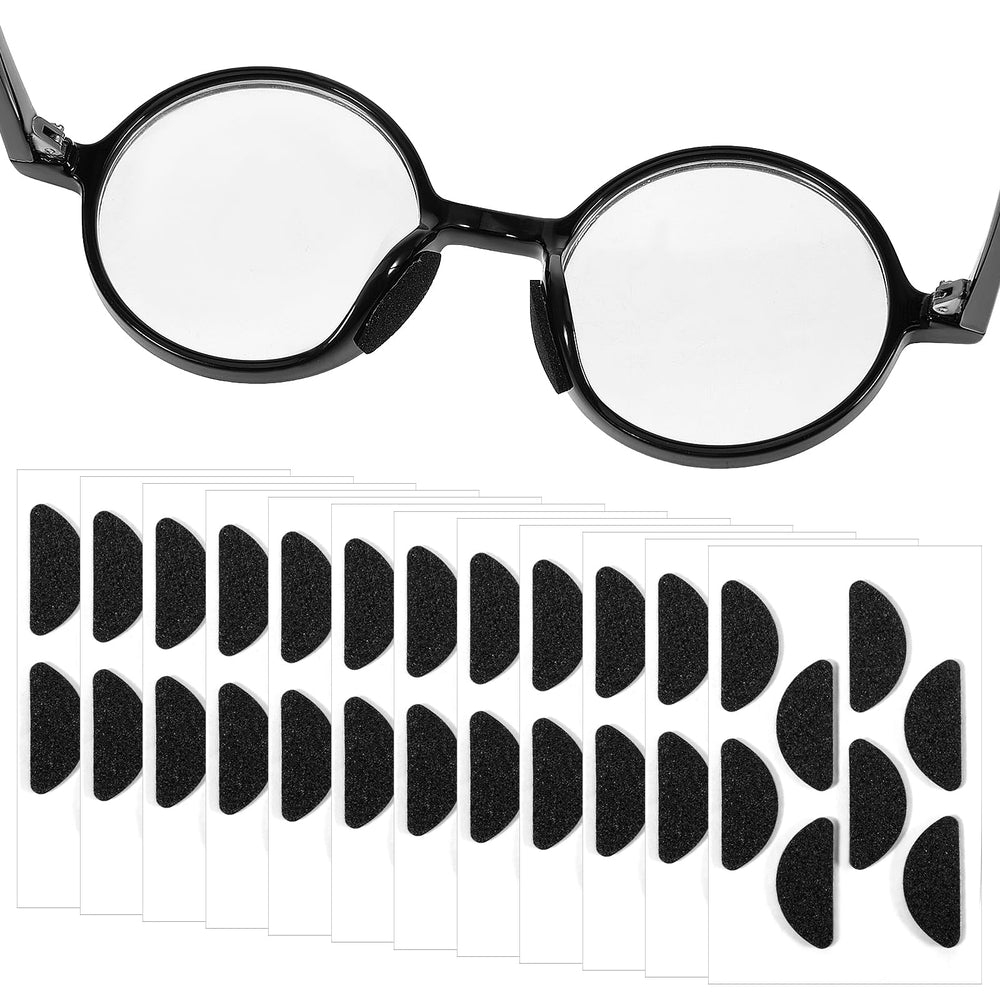 Black D-shaped foam eyeglasses nose pads on sheet