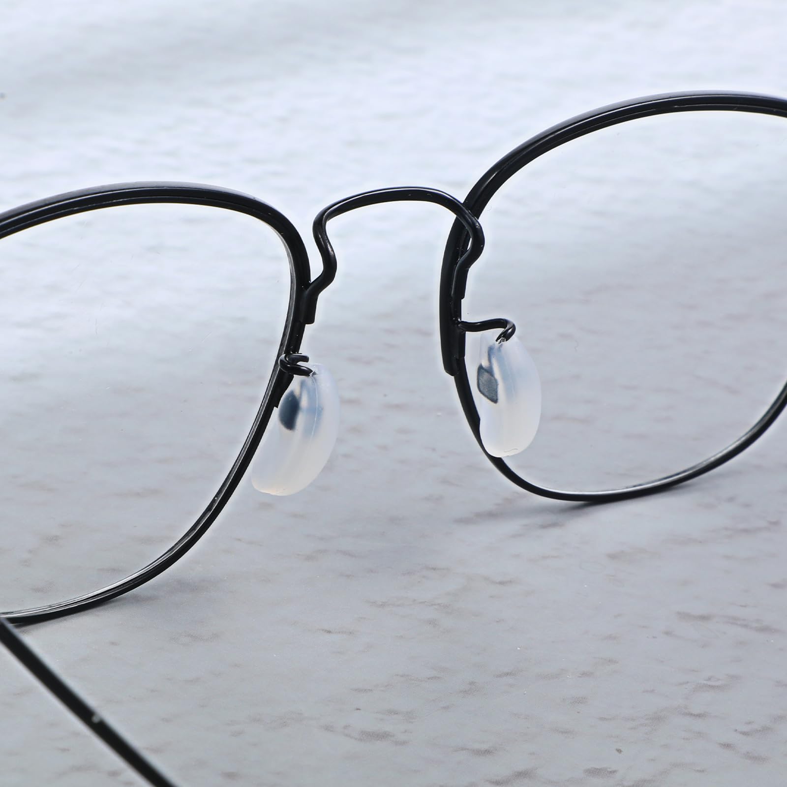 Package showing 10 pairs of white silicone nose pads