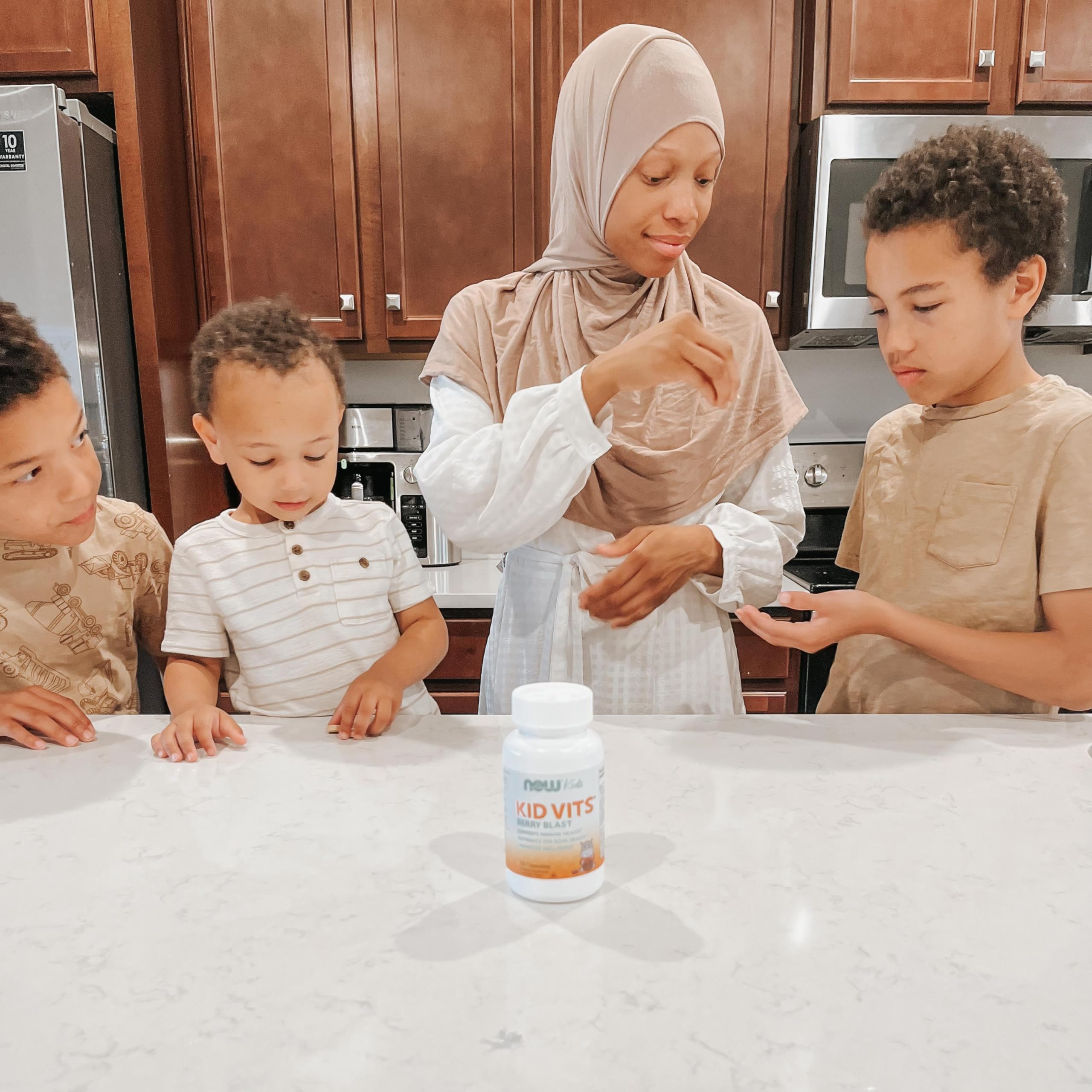 Child taking NOW Kid Vits Berry Lemonade chewables