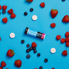 Nuun Wild Berry Energy tablets being poured from tube