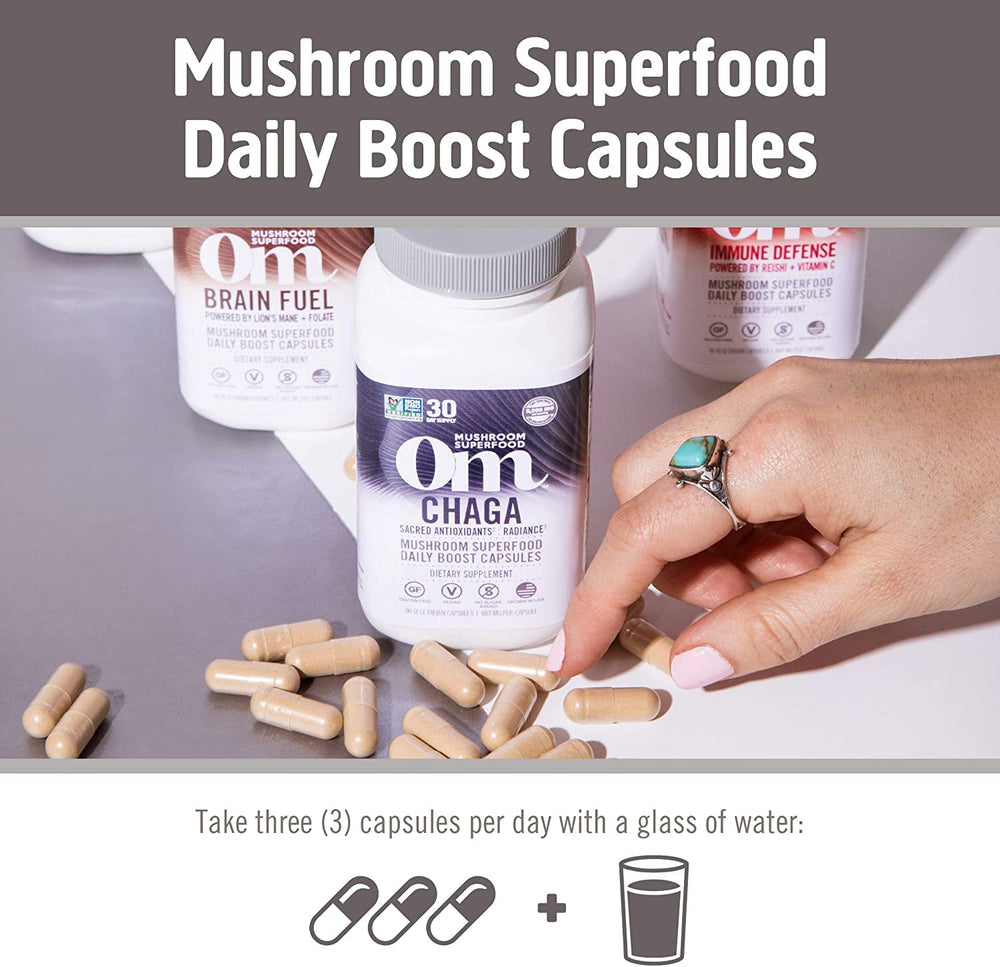Mushroom powder and capsules arranged on wooden surface