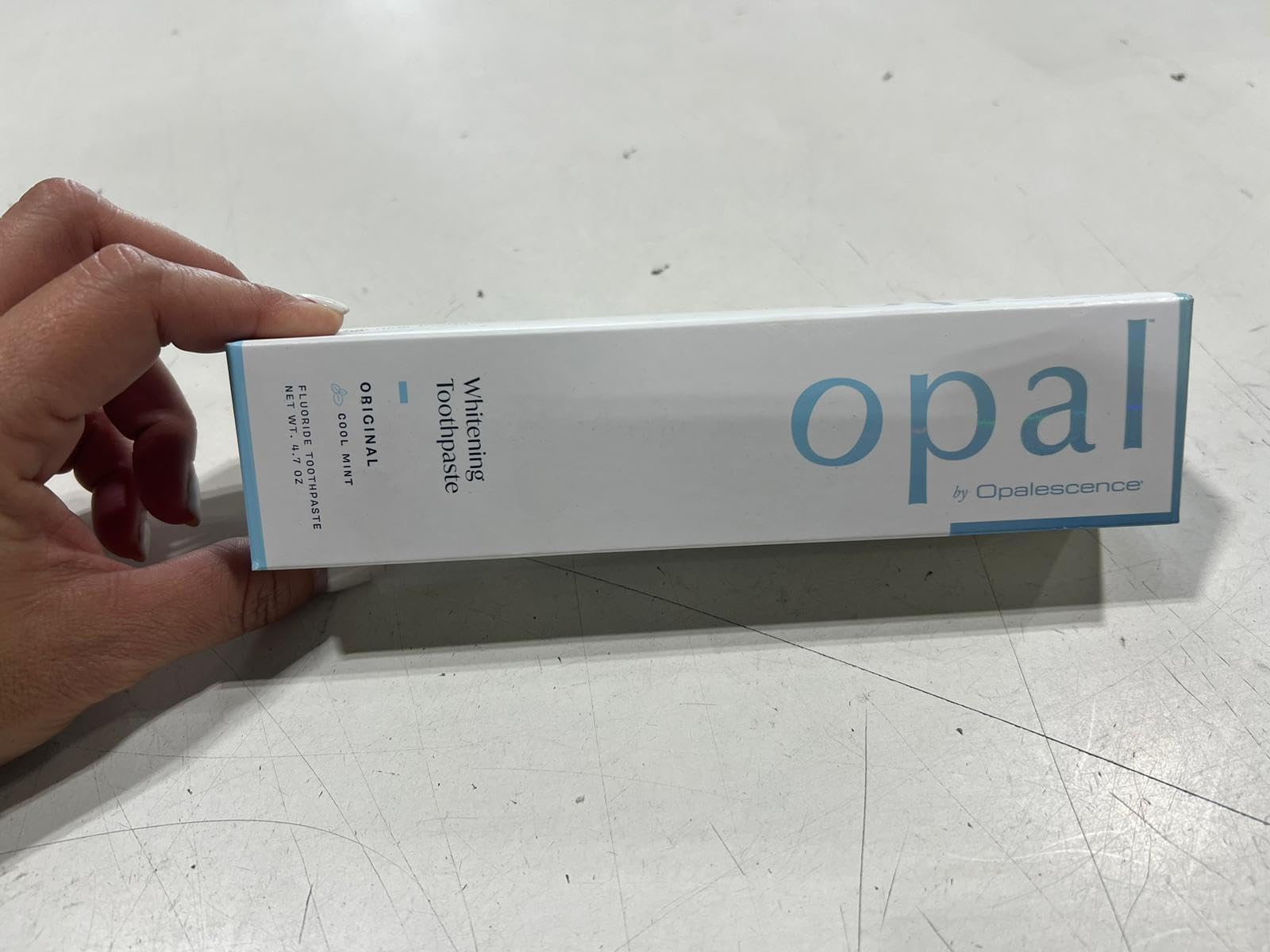 Side view of Opalescence Opal toothpaste pack in display.