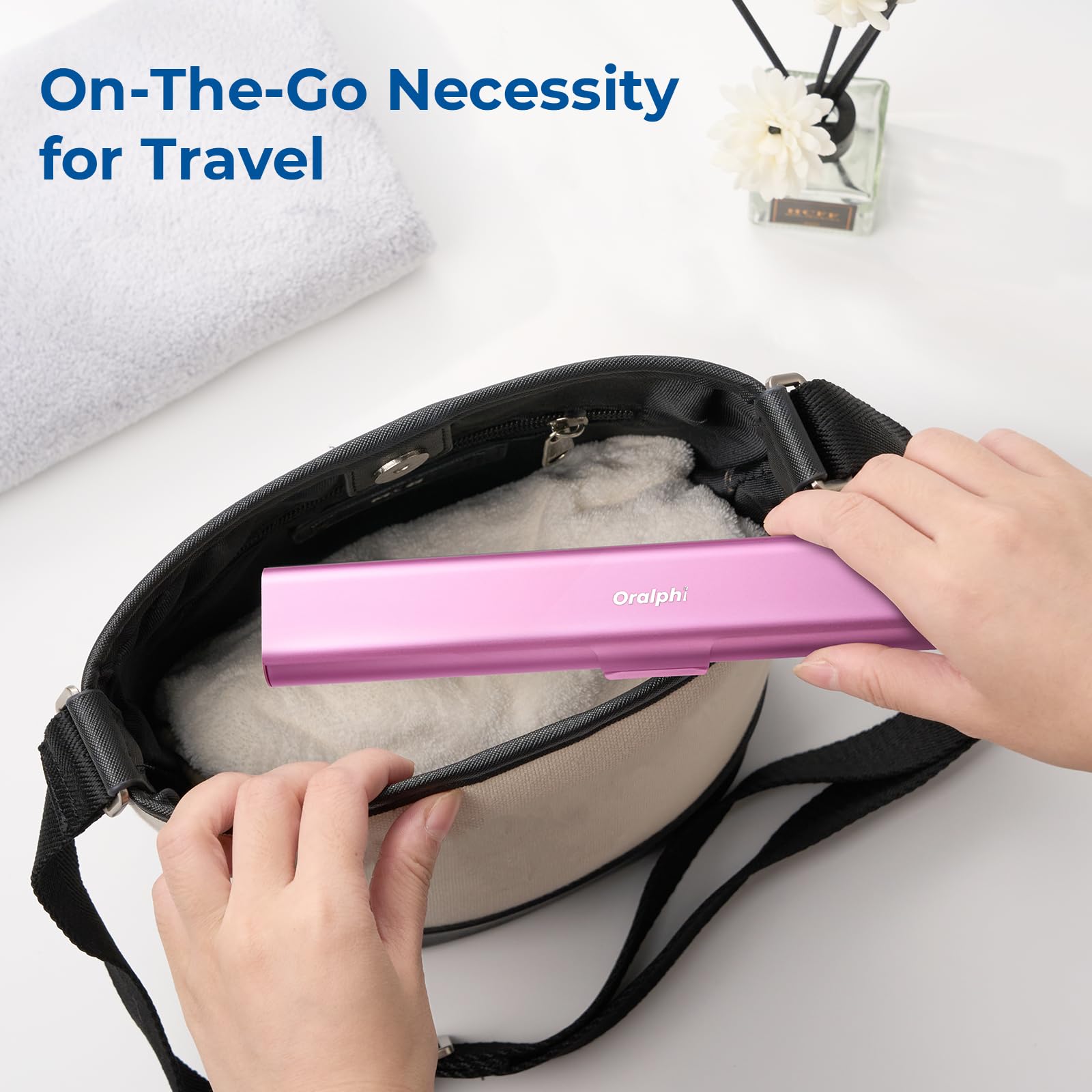 Compact pink aluminum travel case beside a toothbrush for scale
