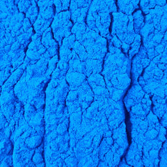 Close-up of vibrant blue spirulina powder (100% phycocyanin)