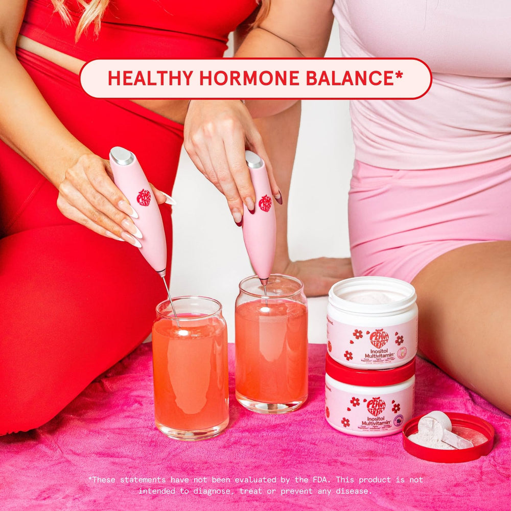 Bottle and scoop of Peach Perfect Inositol Powder