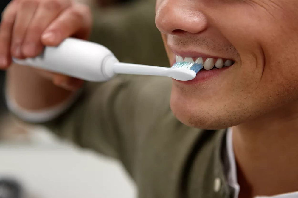 Close-up of Dailyclean toothbrush with attached brush head - side view