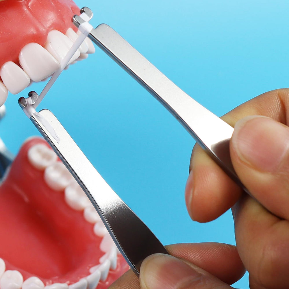 Person using piklip floss holder to clean between teeth