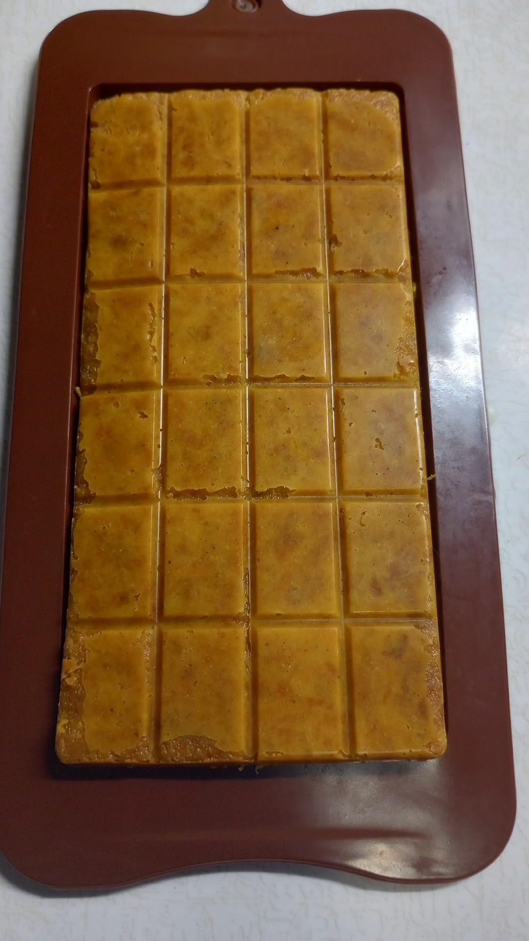 Unwrapped Prymal Instinct Pemmicanesque bar showing dense meat and tallow texture