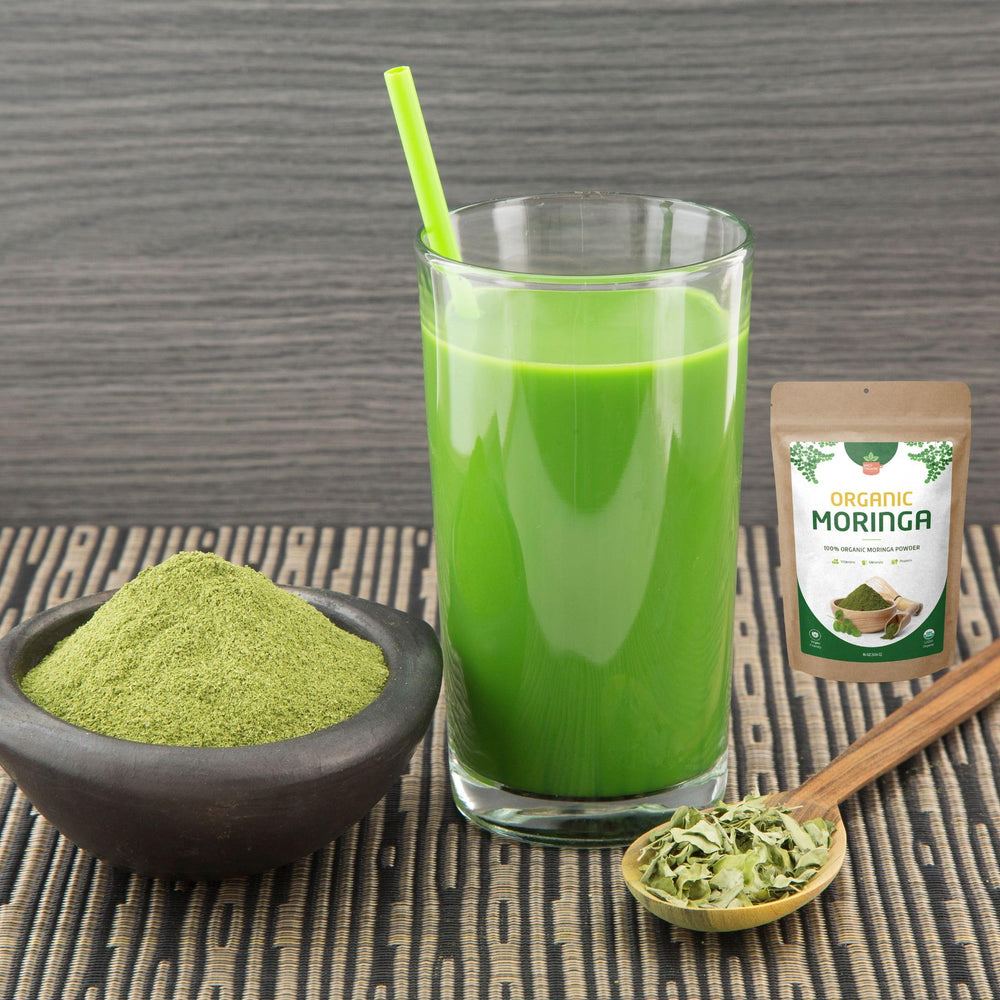 Pure raw moringa leaf powder on white background