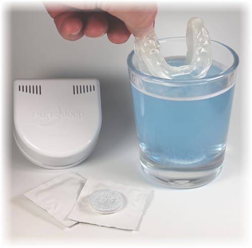 Minty blue effervescent tablet next to a glass of water