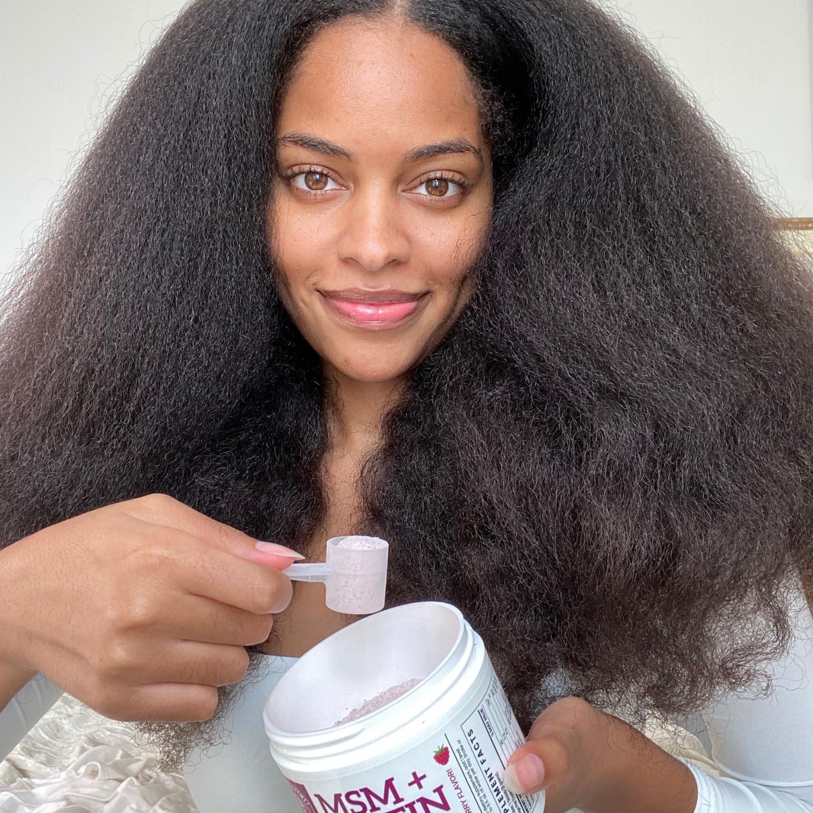 Scoop dispensing powder into water