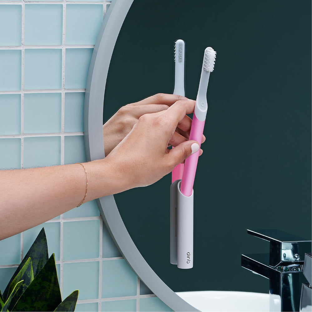 Replaceable brush head and AAA battery included with magenta quip toothbrush