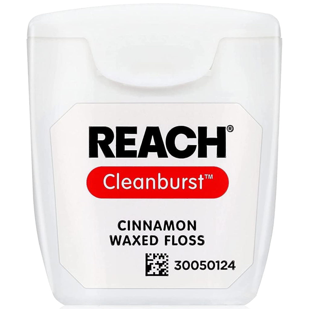 Close-up of cinnamon-flavored floss between teeth