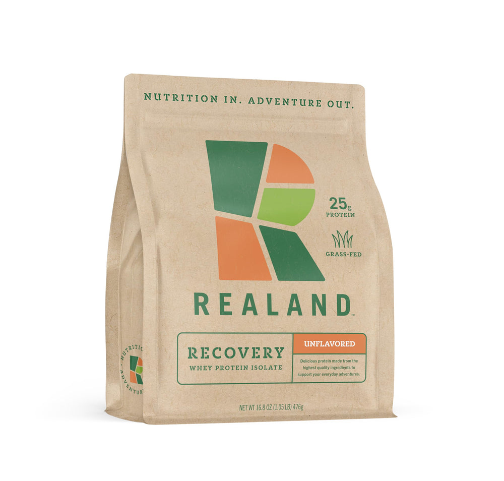 Realand Whey Protein Isolate tub highlights grass-fed protein for post-workout recovery.