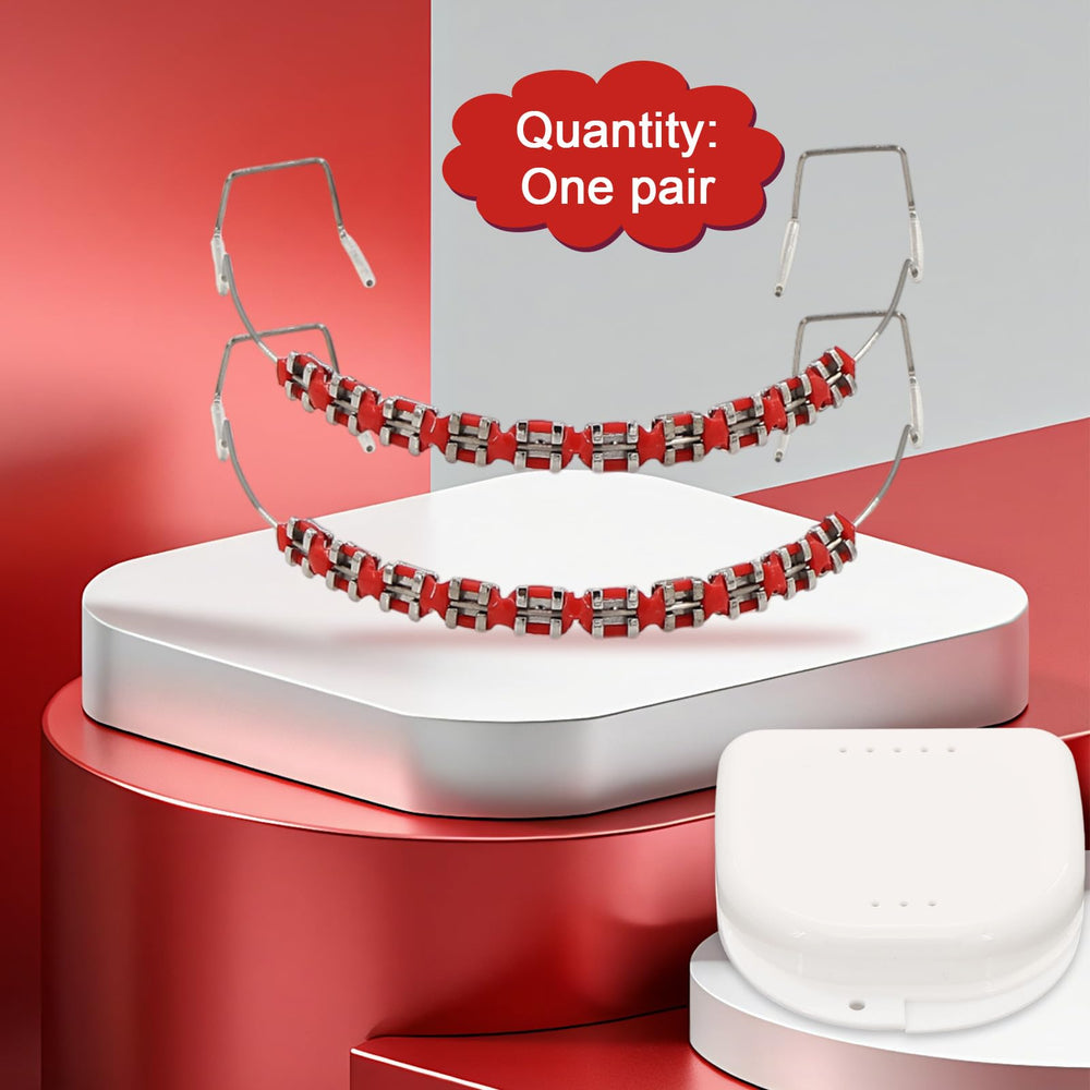 Close-up of metal brackets and orthodontic ligature ties in red