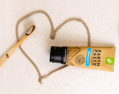 Close-up of Earthpaste tube showing minty paste