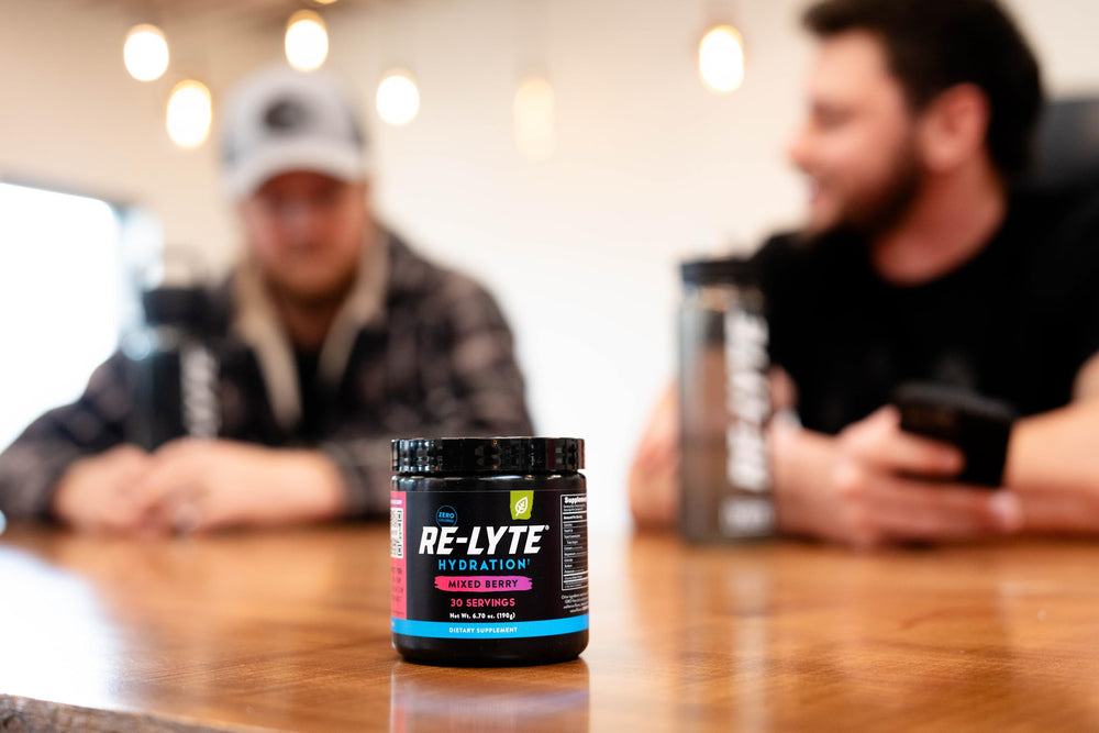 Lifestyle image of the jar with berries and a glass of drink