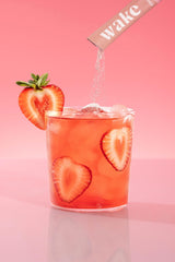 Prepared drink in a glass with pink hue