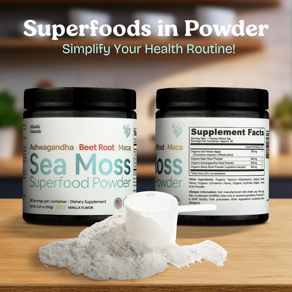 Scooping sea moss powder with ashwagandha, beet root, and maca into a glass