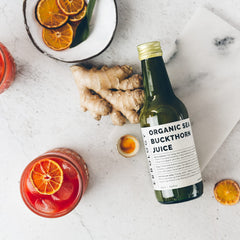 Sea buckthorn juice bottle on white background