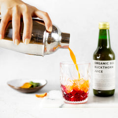 Close-up of sea buckthorn juice bottle showing label and cap