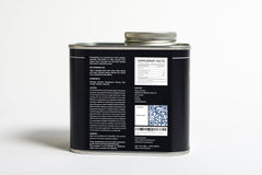 Open bottle with capsules spilled on a white surface