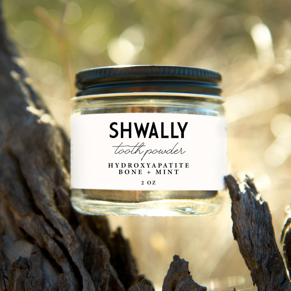 Close-up of Shwally Tooth Powder texture in a spoon