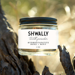 Close-up of Shwally Tooth Powder texture in a spoon
