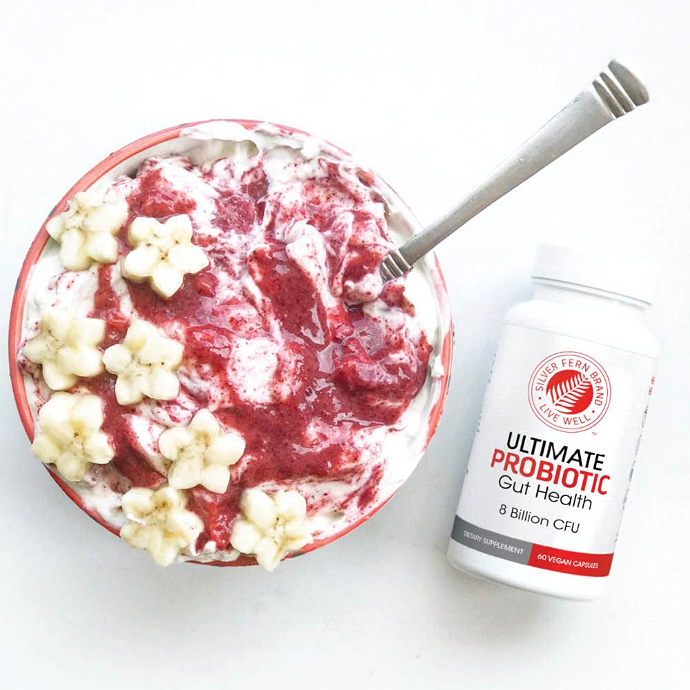 Lifestyle image of a person taking a probiotic capsule