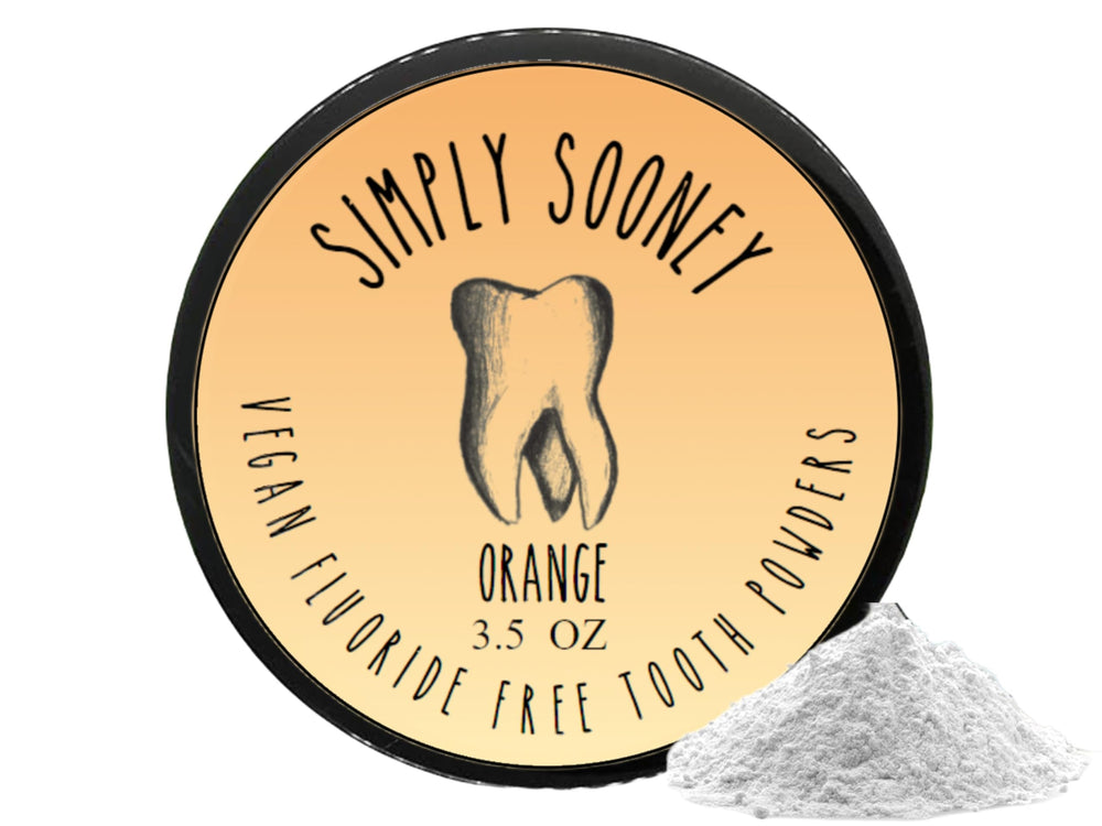 Scoop of orange-flavored tooth powder