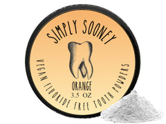 Scoop of orange-flavored tooth powder