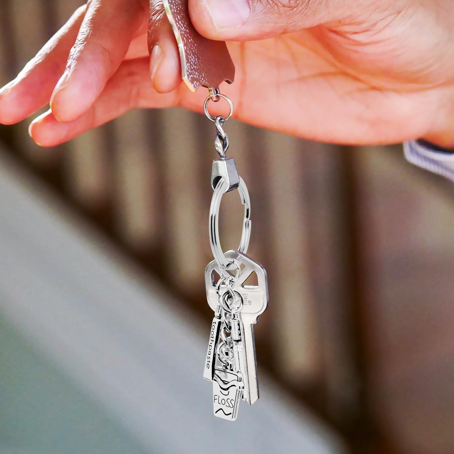 Front view of silver alloy dental keychain with toothbrush charm