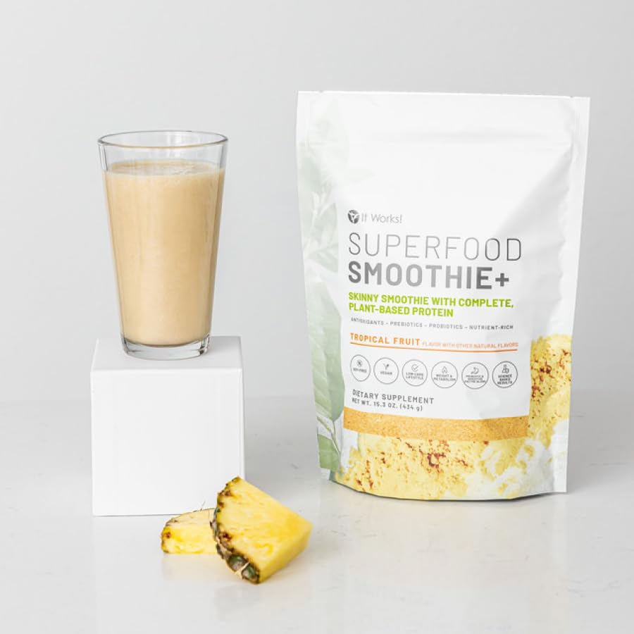 Tropical fruits beside IT WORKS Smoothie+ packaging