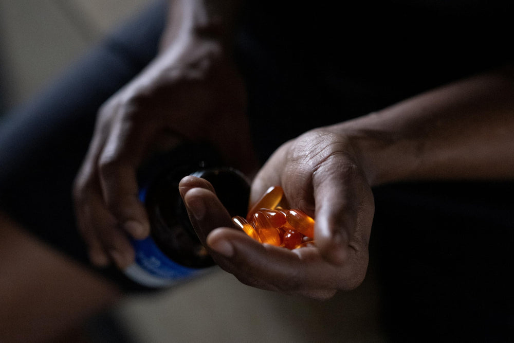 Close-up of softgels beside the bottle label