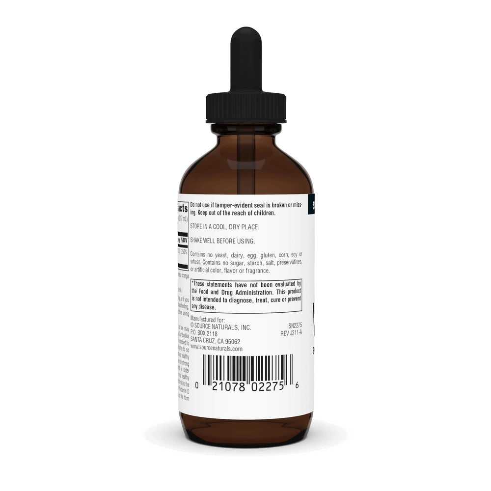 Dropper dispensing Vitamin D-3 liquid into a glass