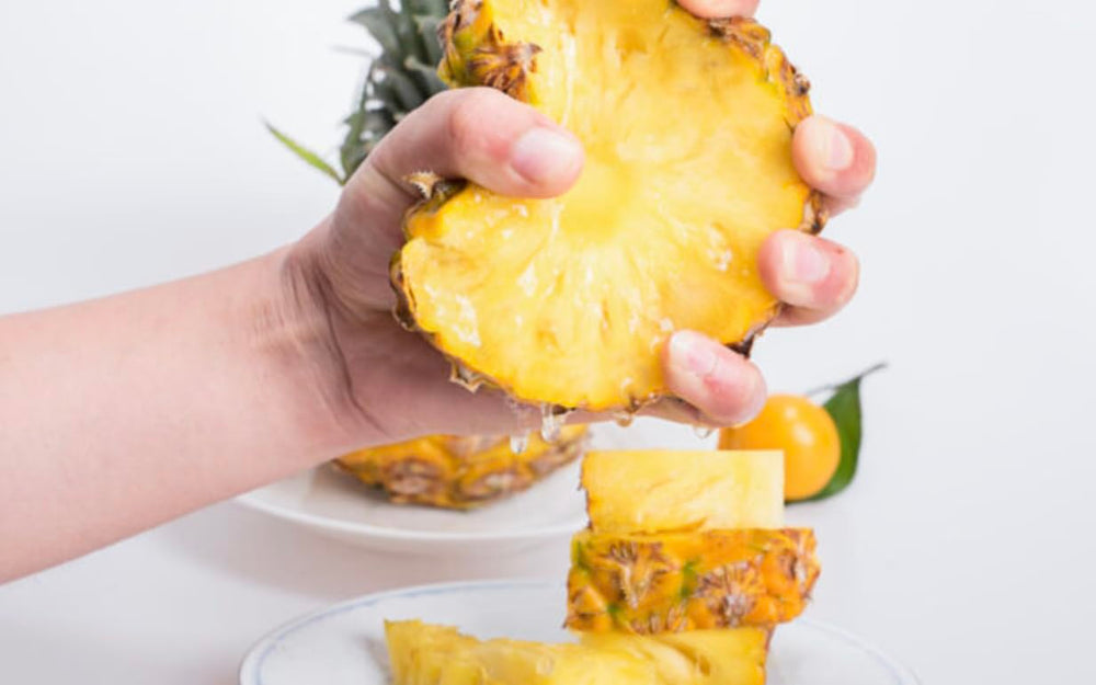 Lifestyle shot: pouring pineapple-flavored liquid collagen into a glass