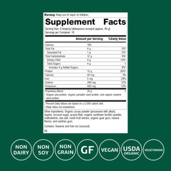 Standard Process Veg-E Complete Pro chocolate powder scoop closeup shows organic pea, pumpkin seed, and sesame proteins.