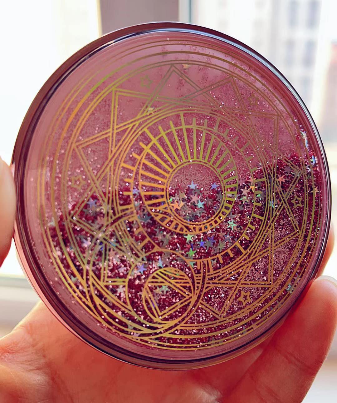 Close-up of pink glitter quicksand lid on contact lens case