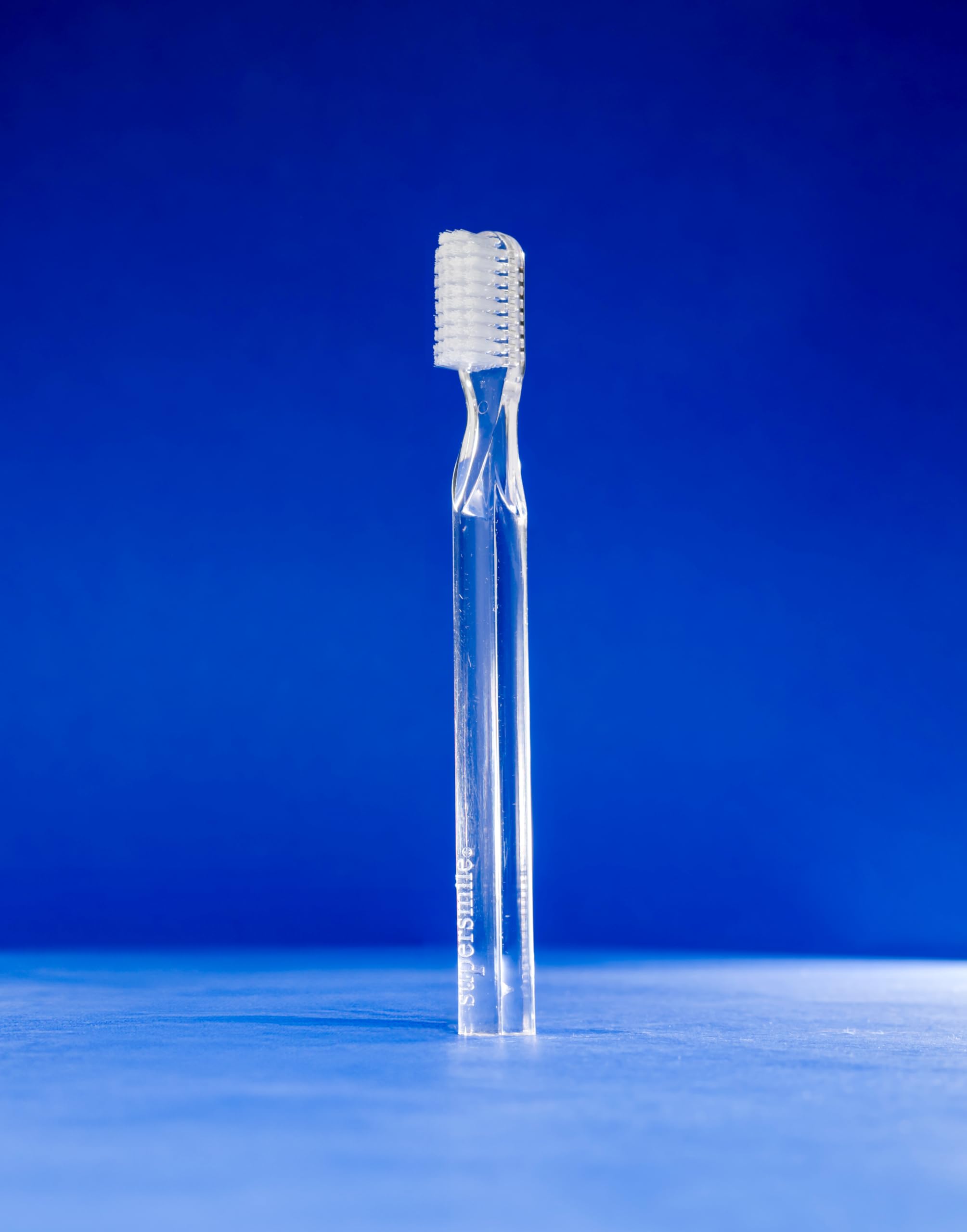 Lifestyle shot of Supersmile toothbrush in use