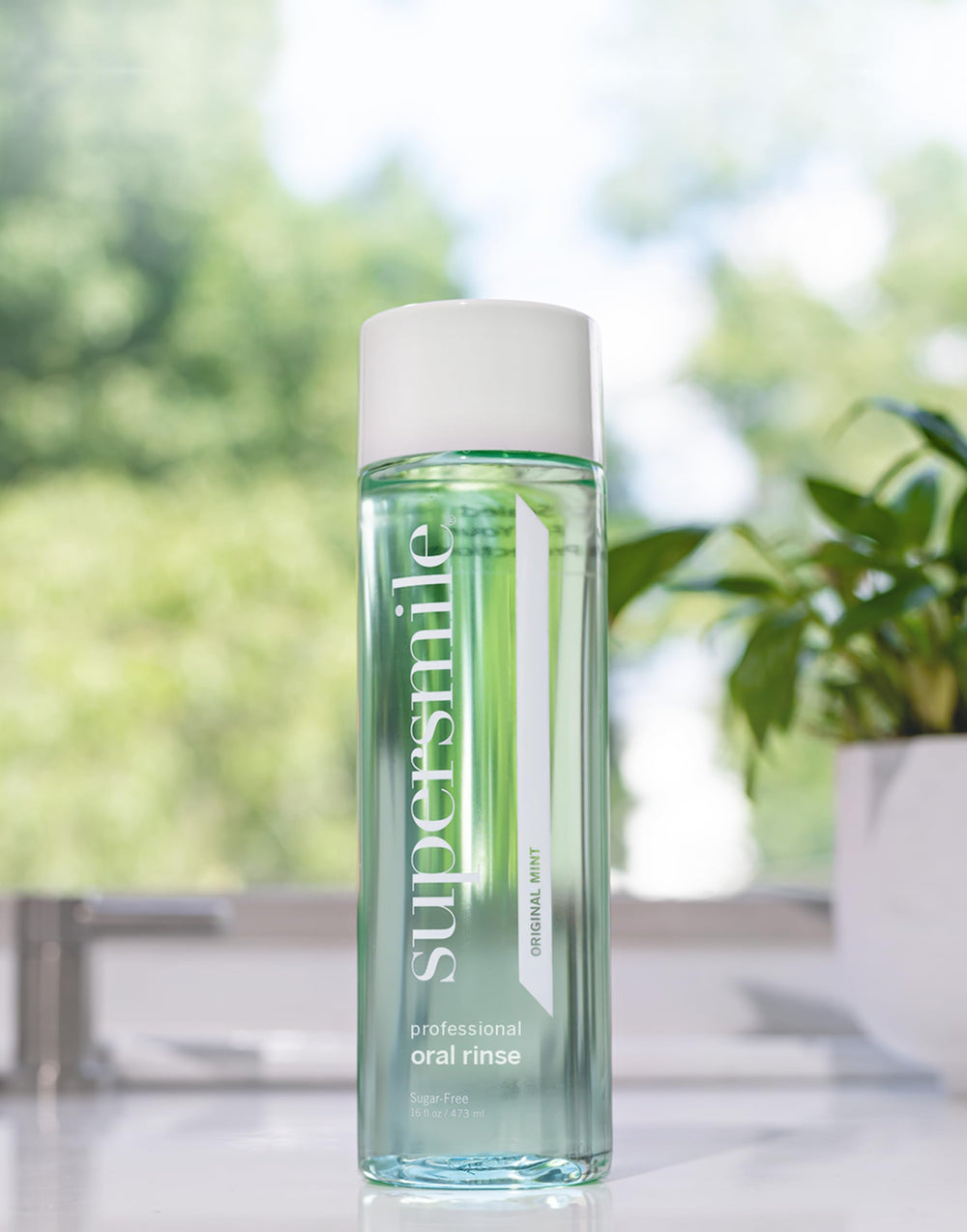 Supersmile Oral Rinse bottle with mint leaves