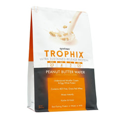 Syntrax Trophix scoop beside the jar, ready to blend fast-acting whey with slow-casein.