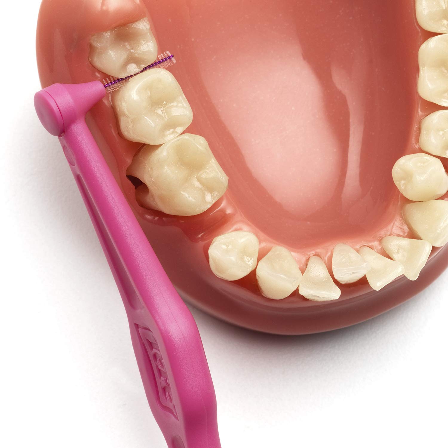 Soft nylon bristles on pink angled interdental brush
