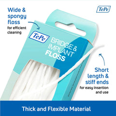 Implant dental floss around an implant and braces close up