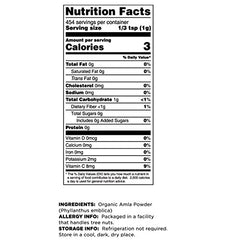 Amla powder in a white bowl with scoop