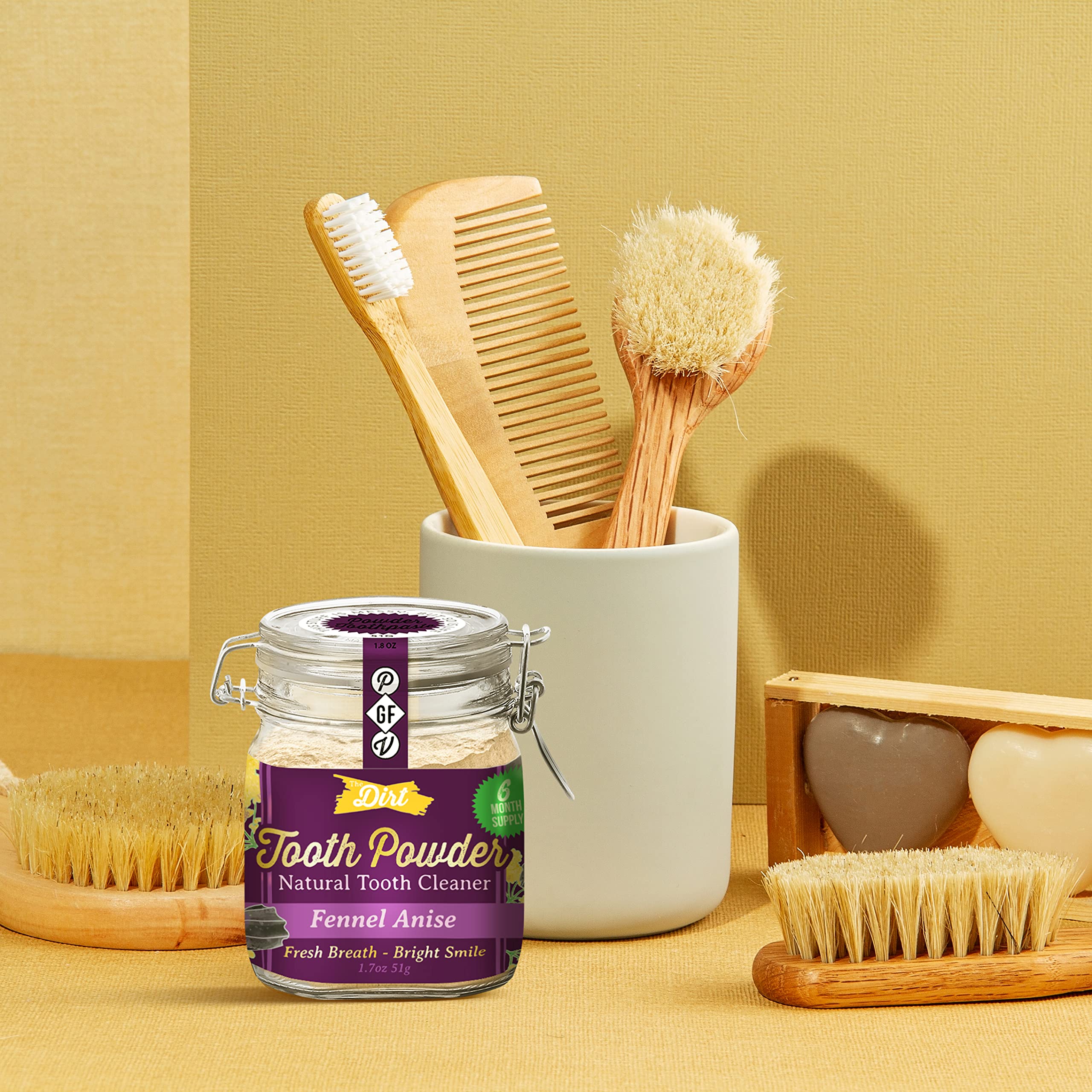 Damp toothbrush dipping into The Dirt tooth powder
